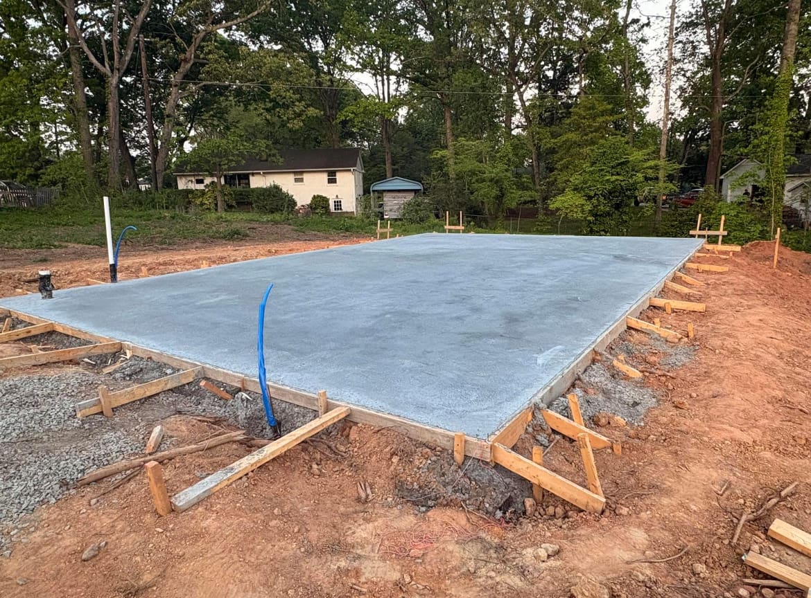 Finished Concrete Foundations job in Charlotte, North Carolina by Local Concrete Lake Norman — clean control-joint pattern, smooth troweled surface, full property protection during pour.