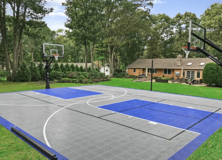 Finished Concrete Basketball Court job in Huntersville, North Carolina by Local Concrete Lake Norman — clean control-joint pattern, smooth troweled surface, full property protection during pour.